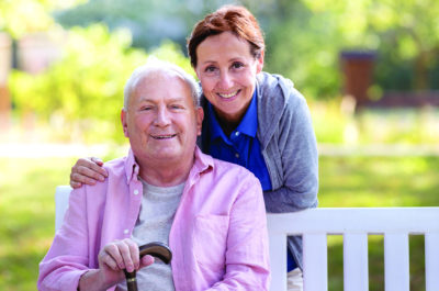 Caregiver And Senior Man Enjoy Outdoors