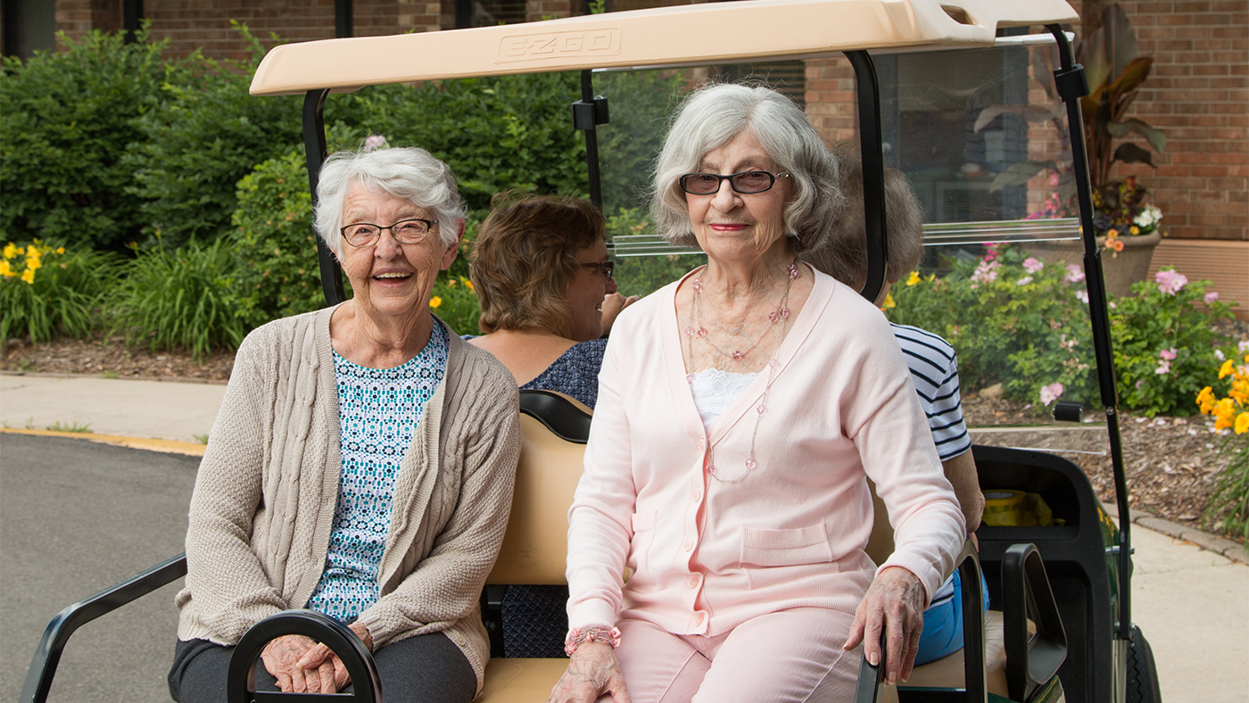 Residents On A Golf Cart Ride